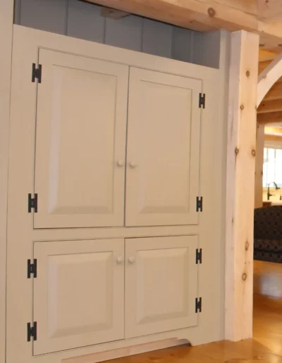 A white built-in in the living room of an Early New England home | Custom Built Ins