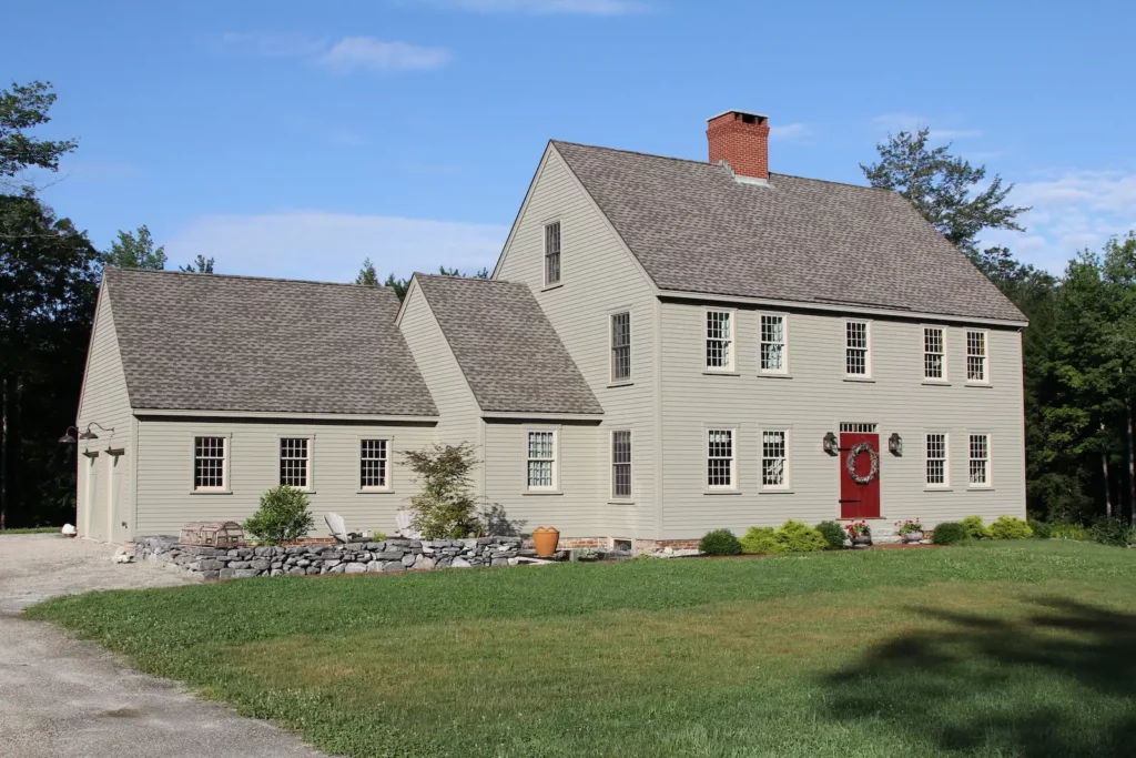 Exterior photo of a gray home with garage from Early New England Homes