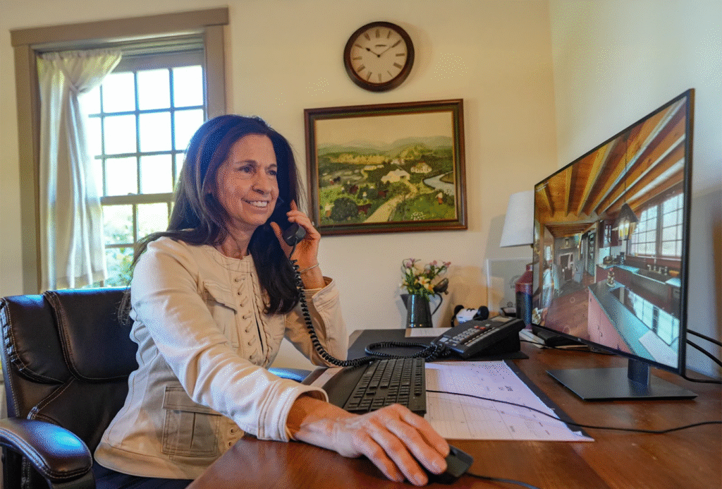 Female salesperson answering the phone at Early New England Homes.